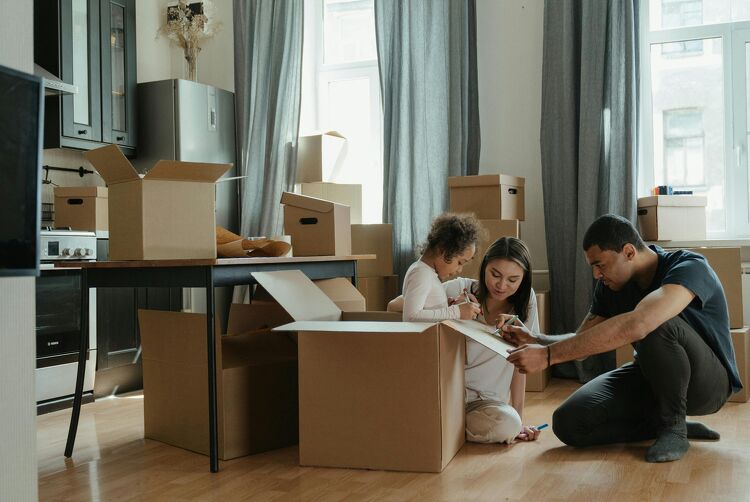 Young family unpacking boxes in their new home after securing a mortgage with Nest Home Loans