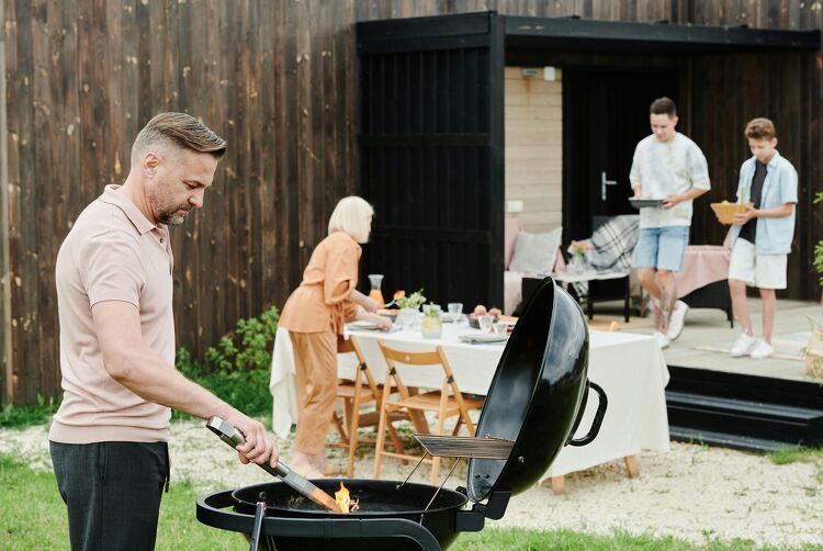 Family enjoying a backyard barbecue at their new home with the support of a mortgage loan
