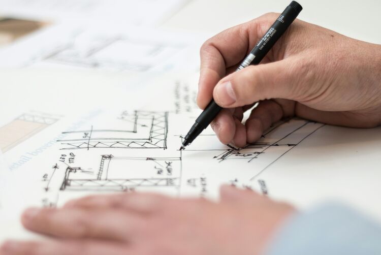 Close-up of an architect or designer drawing house plans.